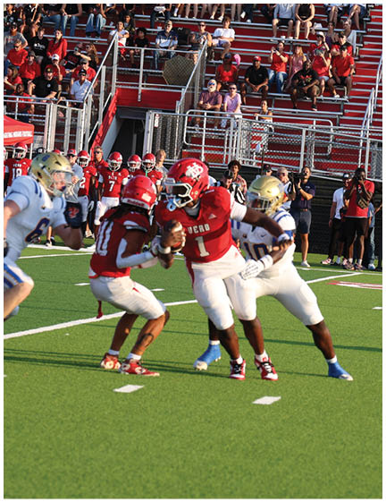 A football player wearing a blue and white uniform. Description generated by AI