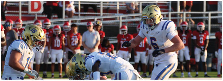 A football player is sliding on the ground. Description generated by AI