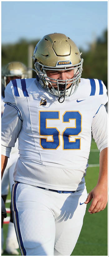 A football player running on the field. Description generated by AI