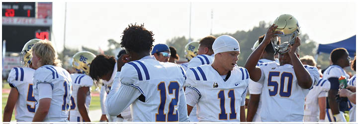 A group of football players on a field. Description generated by AI