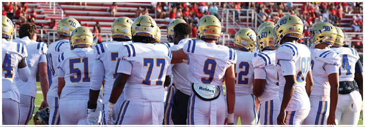 A group of football players on a field. Description generated by AI