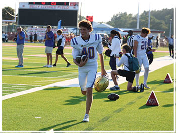 A football player is sliding on the ground. Description generated by AI