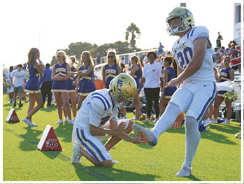 A football player is sliding on the ground. Description generated by AI