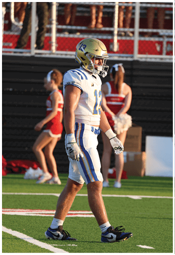 A football player running on the field. Description generated by AI
