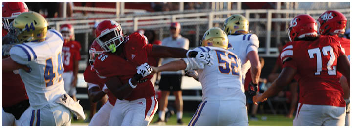 A football player is sliding on the ground. Description generated by AI