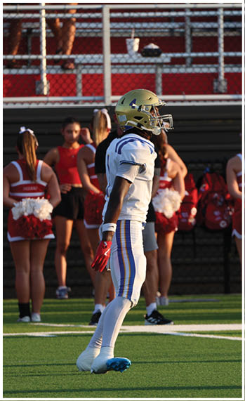 A football player running on the field. Description generated by AI