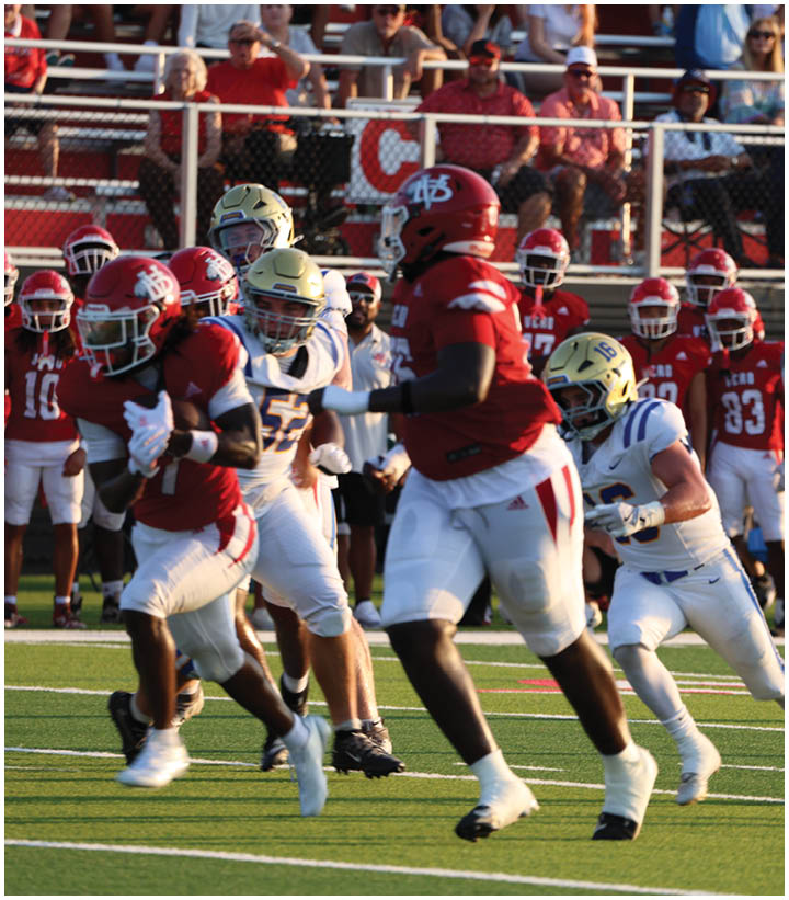 A group of football players wearing black and white uniforms. Description generated by AI