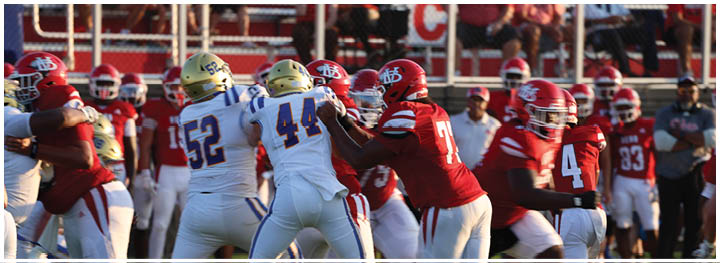 A football player is sliding on the ground. Description generated by AI