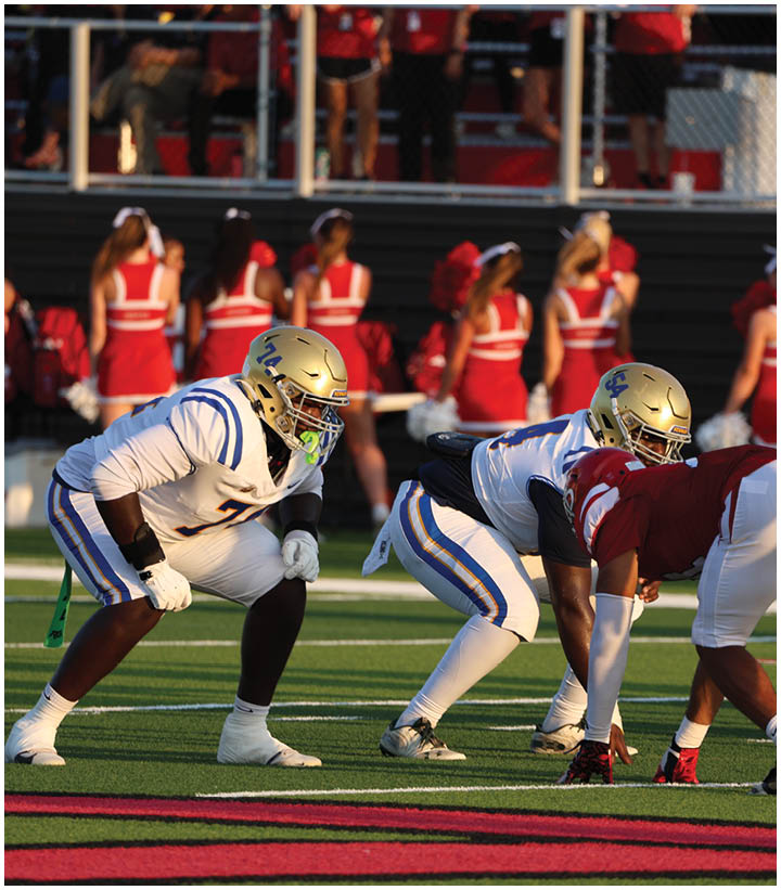 A group of football players wearing black and white uniforms. Description generated by AI