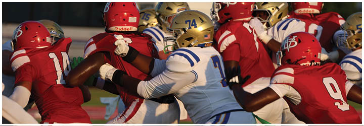 A group of football players on a field. Description generated by AI