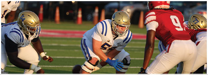 A football player is sliding on the ground. Description generated by AI