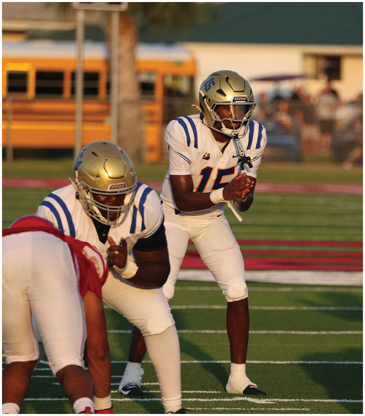 A group of football players wearing black and white uniforms. Description generated by AI