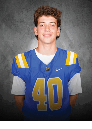 A young man wearing a white and black jersey with the number 14 on it. Description generated by AI