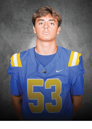 A young man wearing a white and black jersey with the number 14 on it. Description generated by AI