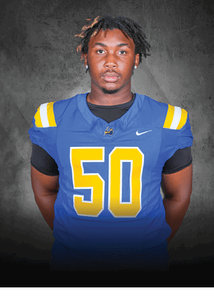 A young man wearing a white and black jersey with the number 14 on it. Description generated by AI