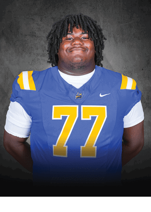 A young man wearing a white and black jersey with the number 14 on it. Description generated by AI