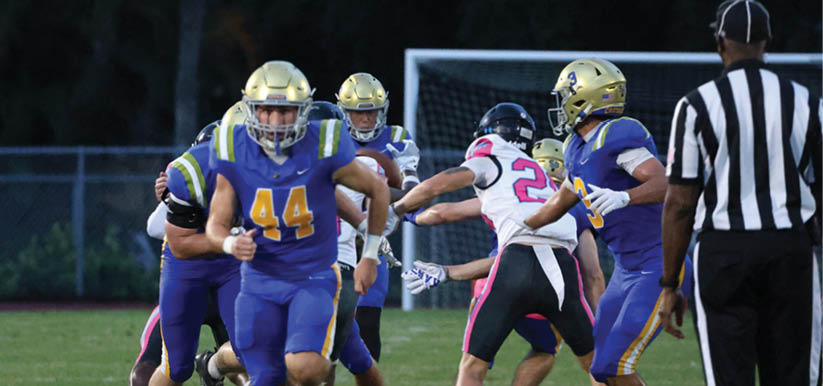 A group of people are kneeling on a field, possibly in a football game. AI generated content