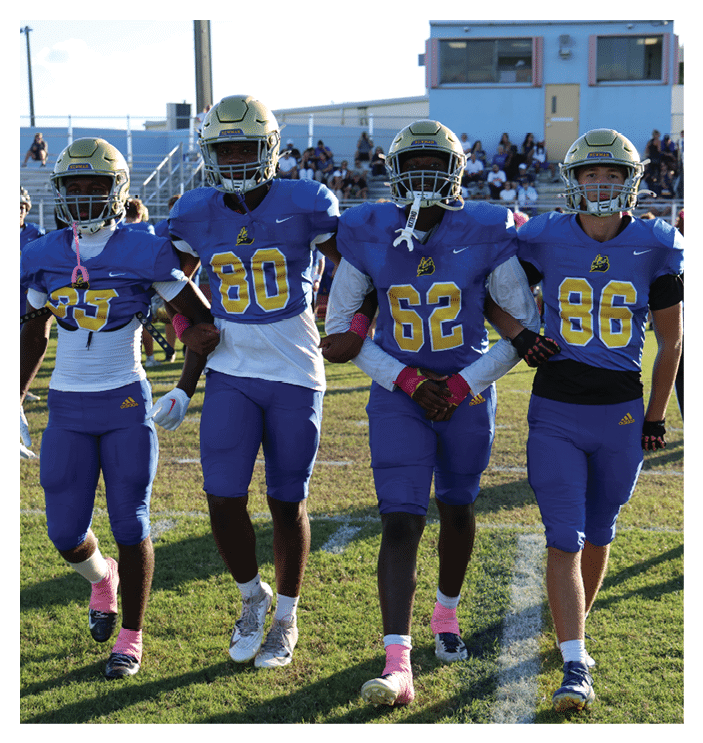 A group of football players walking on the field. AI generated content