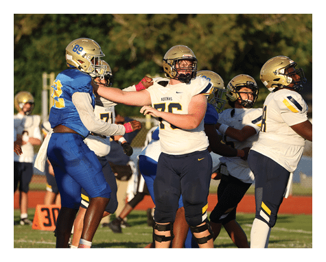 Two football players celebrating a touchdown with one player jumping in the air. AI generated content