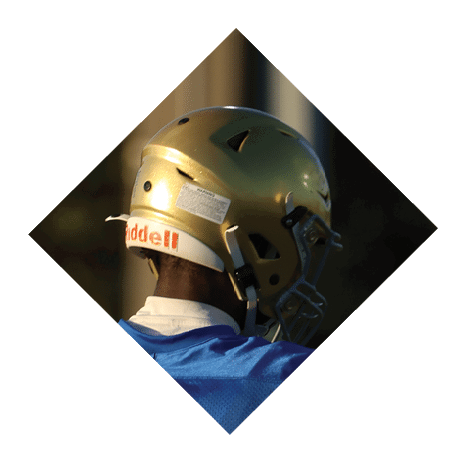 A football player wearing a black jersey with the number 3 kneels on the field. AI generated content