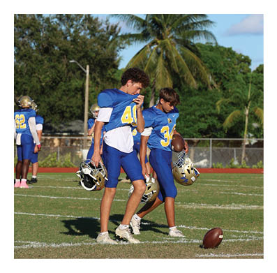 Two men wearing football helmets are talking to each other. AI generated content