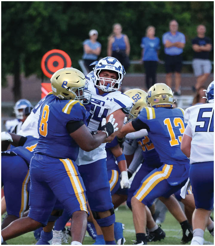 A group of football players wearing black and white uniforms. Description generated by AI