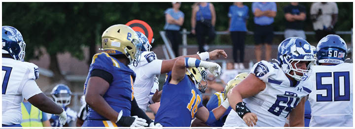 A football player is sliding on the ground. Description generated by AI