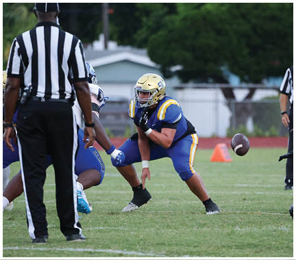 A football player wearing a blue and white uniform. Description generated by AI