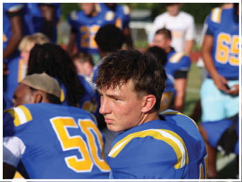 A football player is sliding on the ground. Description generated by AI