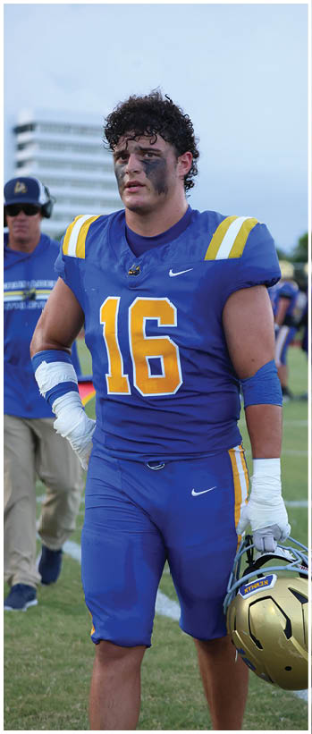 A football player running on the field. Description generated by AI
