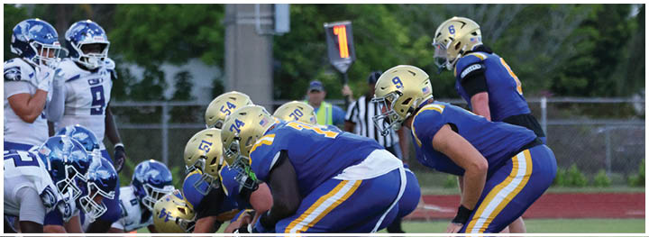 A football player is sliding on the ground. Description generated by AI