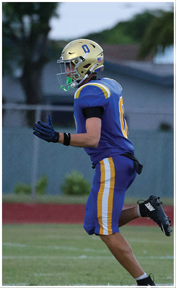 A football player running on the field. Description generated by AI