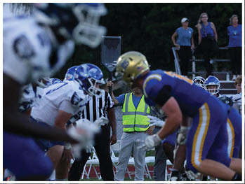 A football player is sliding on the ground. Description generated by AI