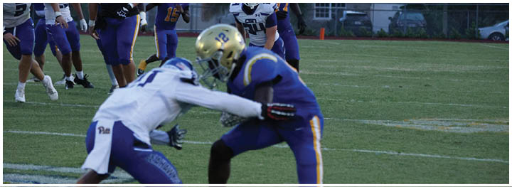 A football player is sliding on the ground. Description generated by AI
