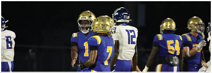 A group of football players on a field. Description generated by AI