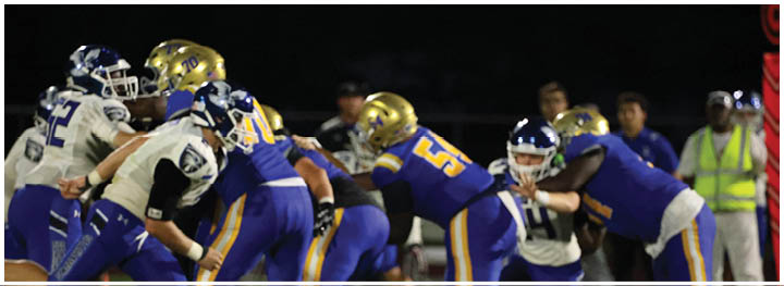 A football player is sliding on the ground. Description generated by AI