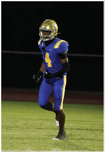 A football player running on the field. Description generated by AI