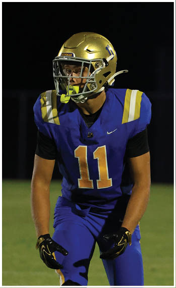 A football player running on the field. Description generated by AI