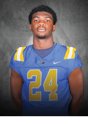 A young man wearing a white and black jersey with the number 14 on it. Description generated by AI