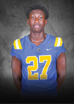 A young man wearing a white and black jersey with the number 14 on it. Description generated by AI