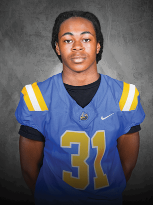A young man wearing a white and black jersey with the number 14 on it. Description generated by AI