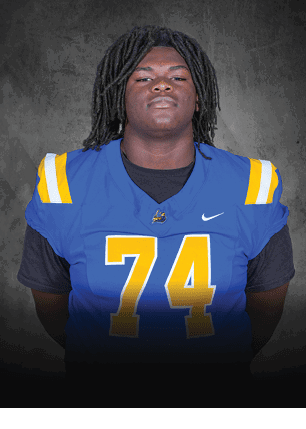 A young man wearing a white and black jersey with the number 14 on it. Description generated by AI