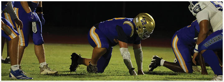 A football player is sliding on the ground. Description generated by AI