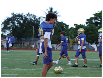 A football player is sliding on the ground. Description generated by AI