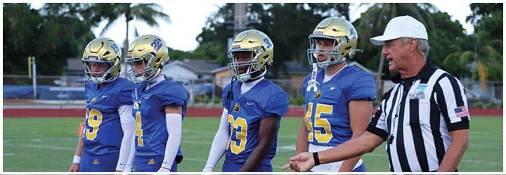 A group of football players on a field. Description generated by AI