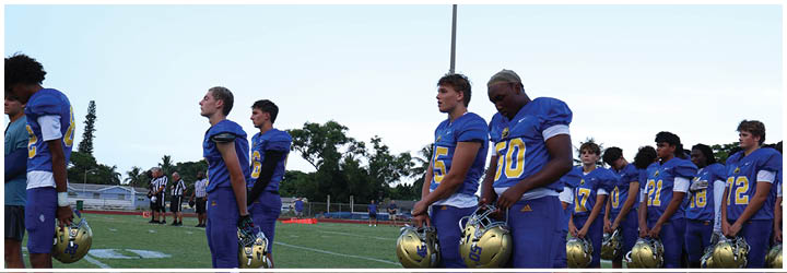 A group of football players on a field. Description generated by AI