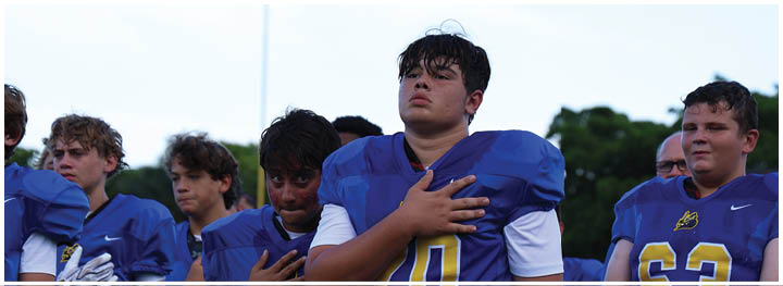 A football player is sliding on the ground. Description generated by AI