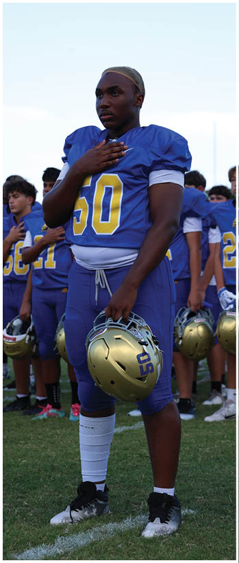 A football player running on the field. Description generated by AI