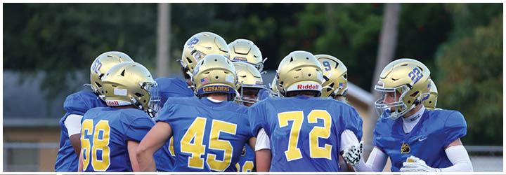 A group of football players on a field. Description generated by AI