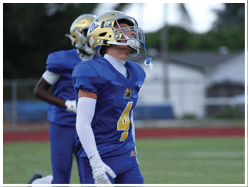 A football player is sliding on the ground. Description generated by AI